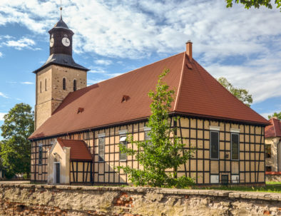 Church of Saint John the Baptist in Pisz from the 17th century (the oldest part - tower). The church, with half-timbered walls, was built in 1737. Masuria, Poland.