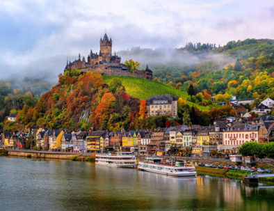 Cochem, Germany, beautiful historical town on romantic Moselle river, city view with Reichsburg castle on a hill in autumn color